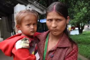 A mother carrying a sick child in rural Nepal. Smart Health Global